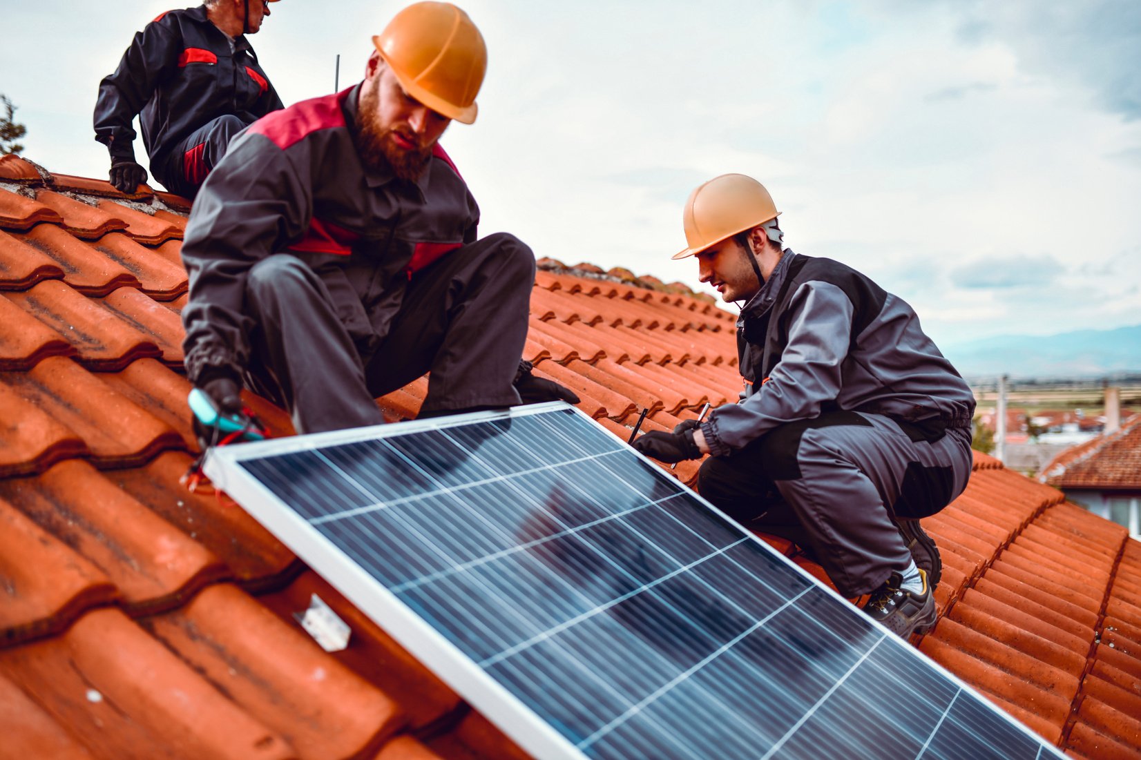 Teamwork By Rooftop Workers Installing Photovoltaic Panel